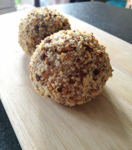 Homemade Scotch Eggs - 2 scotch eggs on a wooden board