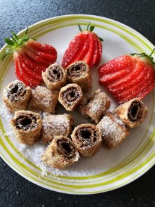 French Toast Doughnuts - little swirls of bread and chocolate spread, served with sliced strawberries