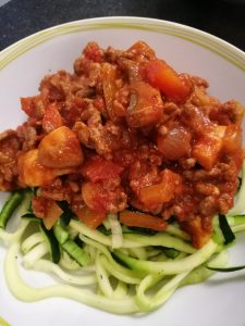 Easy Peasy Spaghetti Bolognese - A bowl with bolognese on top of spiralised courgette