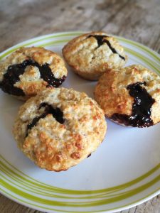 Melt In The Middle Baked Oats - 4 oat muffins on a plate with chocolate sauce drizzled out