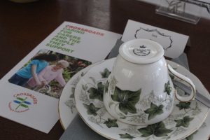 Crossroads Tendring & Colchester - teacup and saucer next to a leaflet