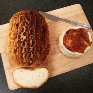 Things I Don't Like About Christmas - A sliced loaf of crusty bread and a baked Camembert 