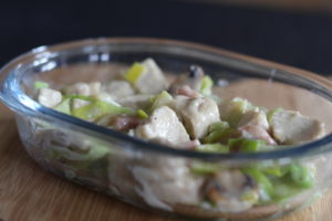 Chicken, bacon and leek pot pie - A close up picture of a single glass pie dish with the pie filling in it