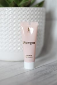 March 19 Glossybox - Baby pink tube with a white cap and Plumper written in gold across the top of the tube