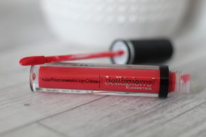 March 19 Glossybox - A tube of red coloured lipstick on its side with the applicator resting on top.