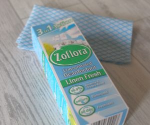 32 Things I've Learnt - A blue and white box with Zoflora, Linen Fresh written on it placed on top of a blue and white cleaning cloth.