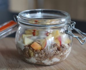 Overnight Cake In A Jar - A jar with layers of cereal, yoghurt and apple.