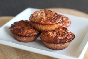 Black Forest Baked Oats - 4 muffins in a pyramid on a white plate