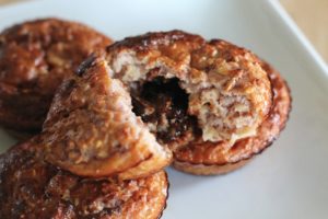 Black Forest Baked Oats - one muffin cut down the middle showing the chocolate inside