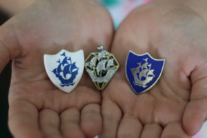 2 different Blue Peter badges being held in hands