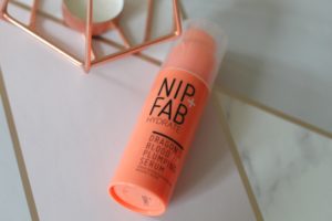 Skincare in your early 30's - An orange bottle lying on it's side with black writing saying Nip + Fab