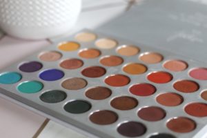 An open palette with 5 rows of circular pans full of different colours