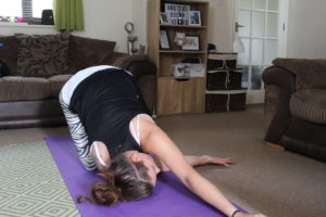 Life Update - Carly doing a "thread the needle" yoga pose, in a weird, tangled looking way.