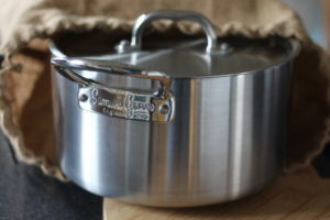 Minced Beef Hotpot - A silver casserole pan emerging from a hessian bag