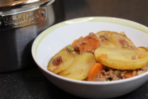 A bowl of Minced Beef Hotpot sat next to the Samuel Groves pan it was cooked in.