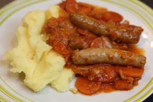 Sausage Casserole - A plate of  sausage casserole sitting on a mound of mashed potatoes