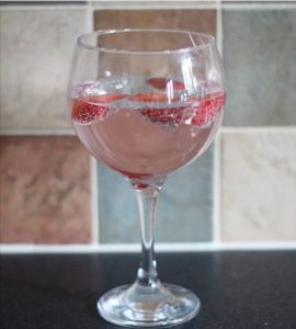 10 Things I've learnt in my early 30's - A glass of pink gin with raspberries floating in it