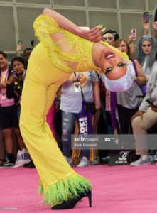 Joint Hypermobility Syndrome - Yvie Odly bent backwards looking at the camera on the pink carpet