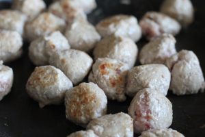 Gluten Free IKEA Style Meatballs browning in a frying pan