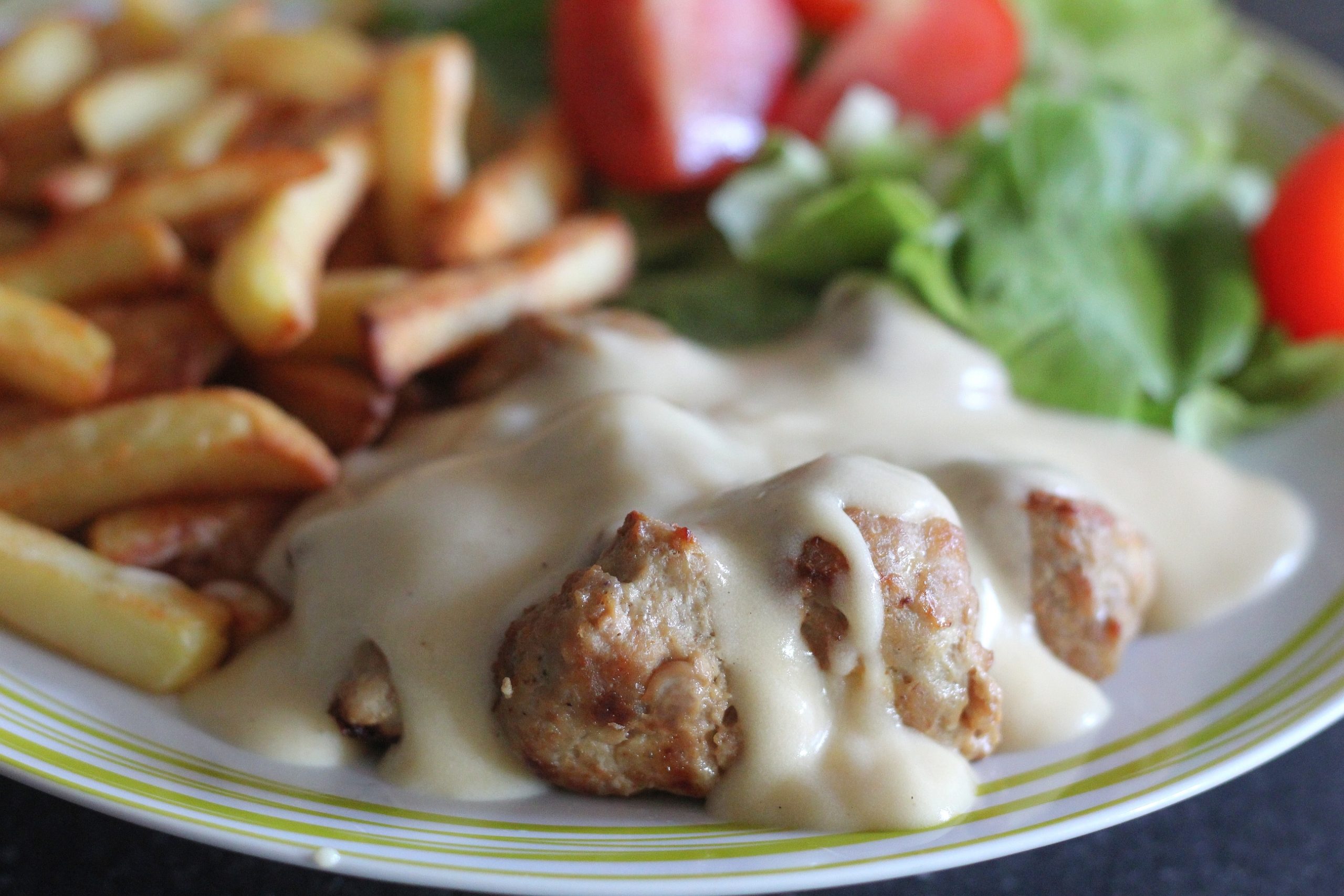 A close up of the gluten free IKEA style meatballs with the sauce over the top