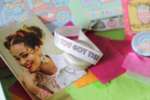 The festival bracelet which is white with the words "You got this" on it.