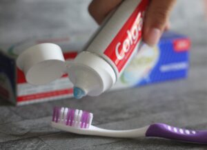 Fun ways of getting kids to look after their teeth - someone squeezing toothpaste onto a brush